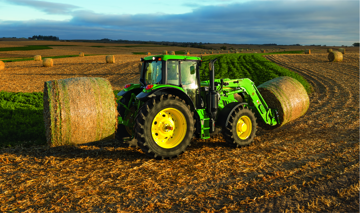john deer tractor moving hay