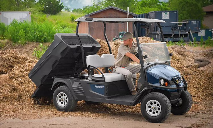 Person working with Cushman equipment