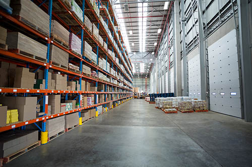 Clean warehouse interior with closed dock doors and empty staging area