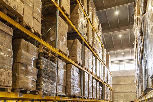 Bulk storage warehouse with high racks and forklifts in operation
