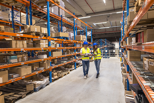 Interior of a modern distribution center with employees inspecting inventory